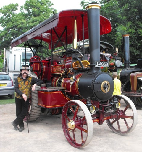 Captain Bellinger poses nonchalantly with traction engine